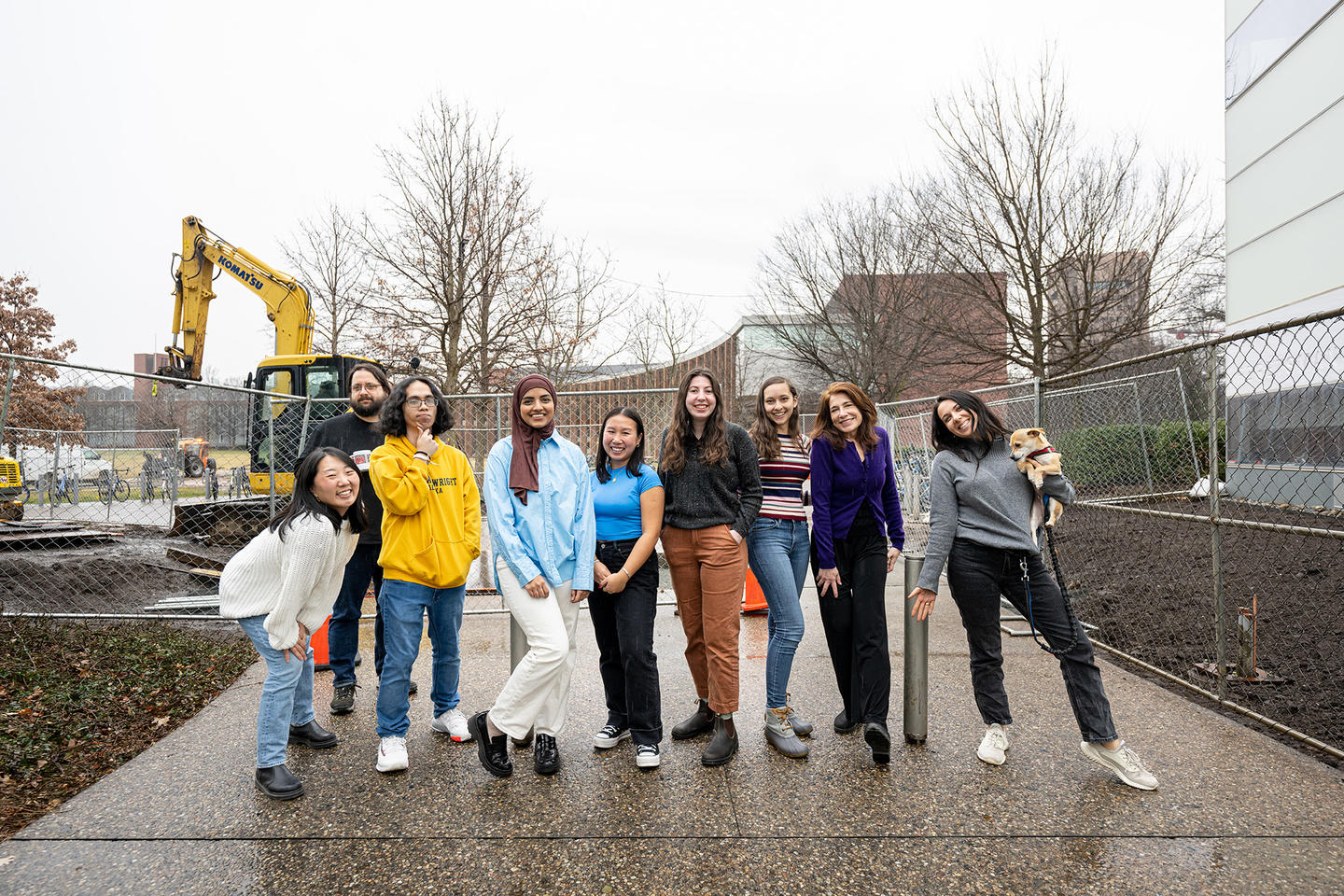 Lab team outside with construction behind